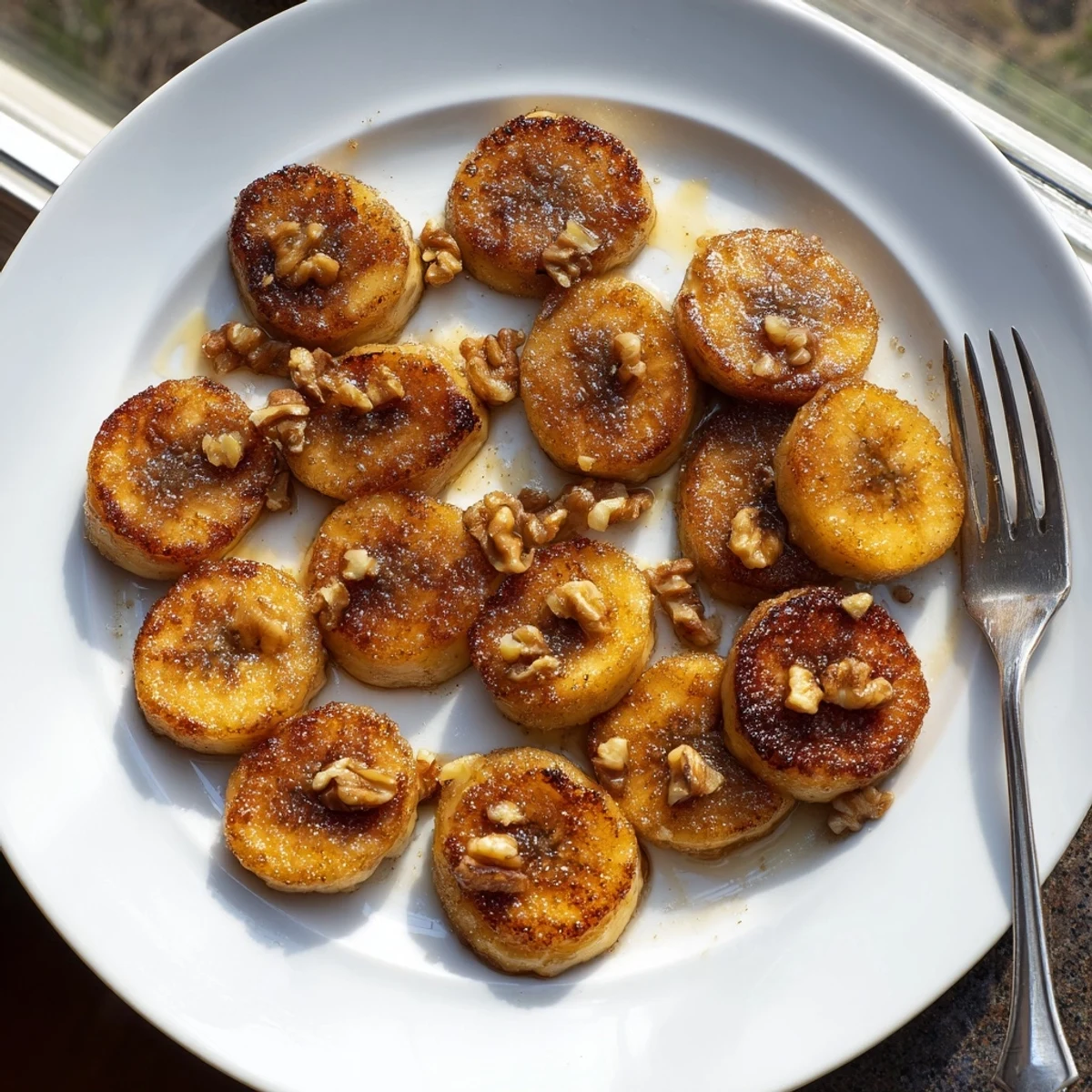 Golden brown pan fried cinnamon bananas caramelized in butter with a dusting of warm spice