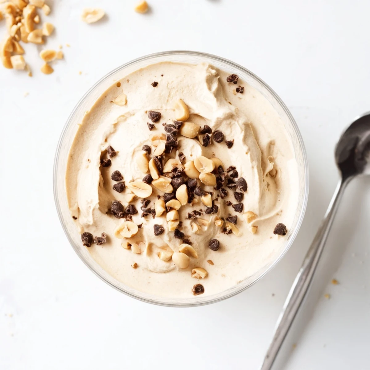 Smooth peanut butter and Cool Whip mousse swirl topped with peanuts and mini chocolate chips for a sweet treat.