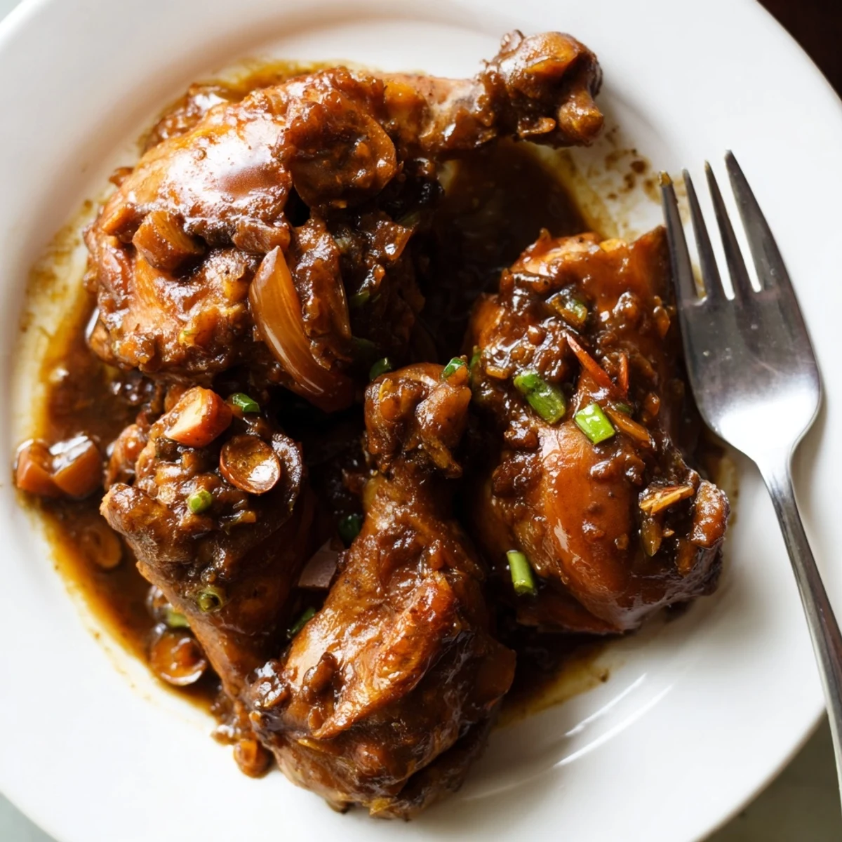 Golden seared Jamaican brown stew chicken with bell peppers and carrots