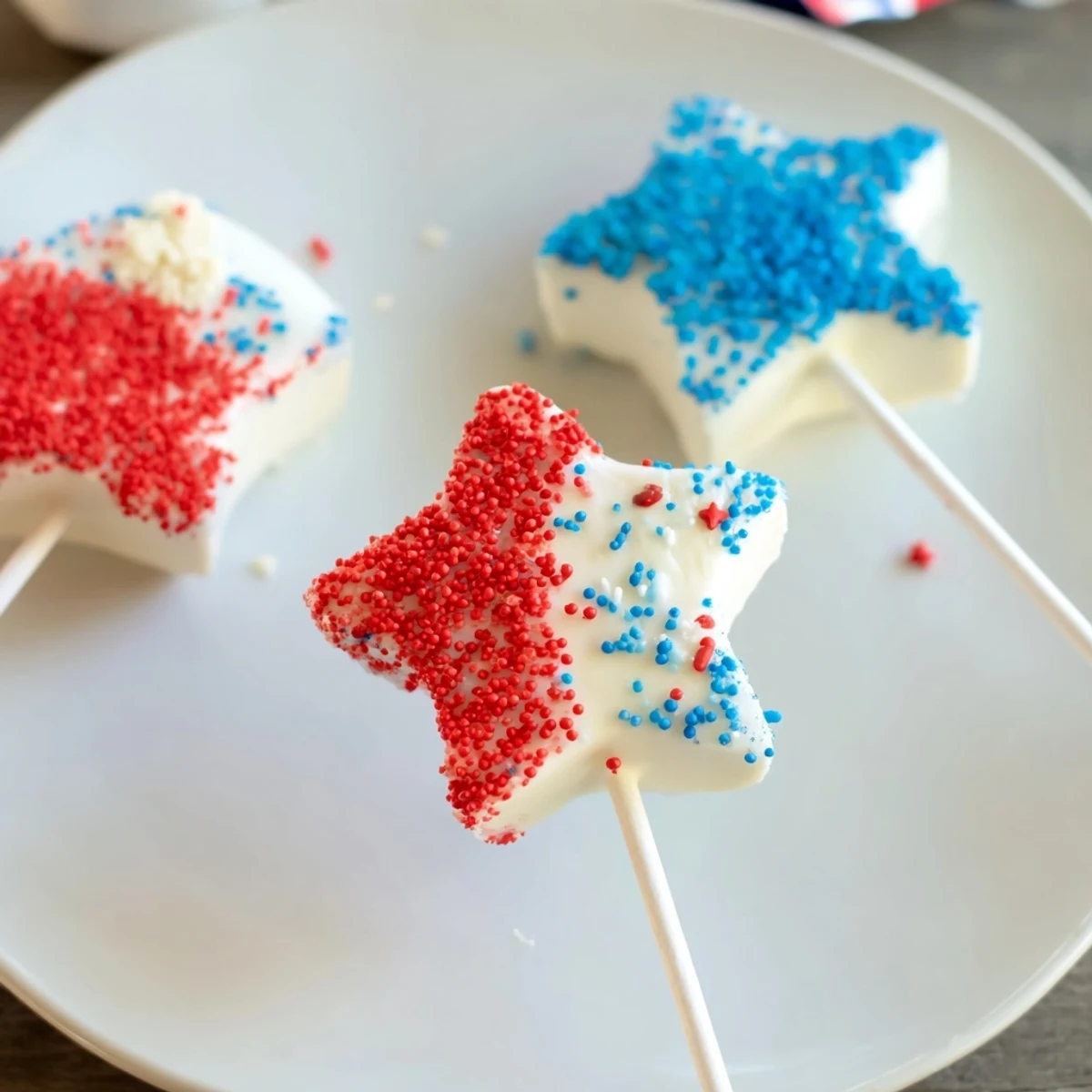 A bite revealing creamy center in a Fourth Of July Star Cheesecake Pops