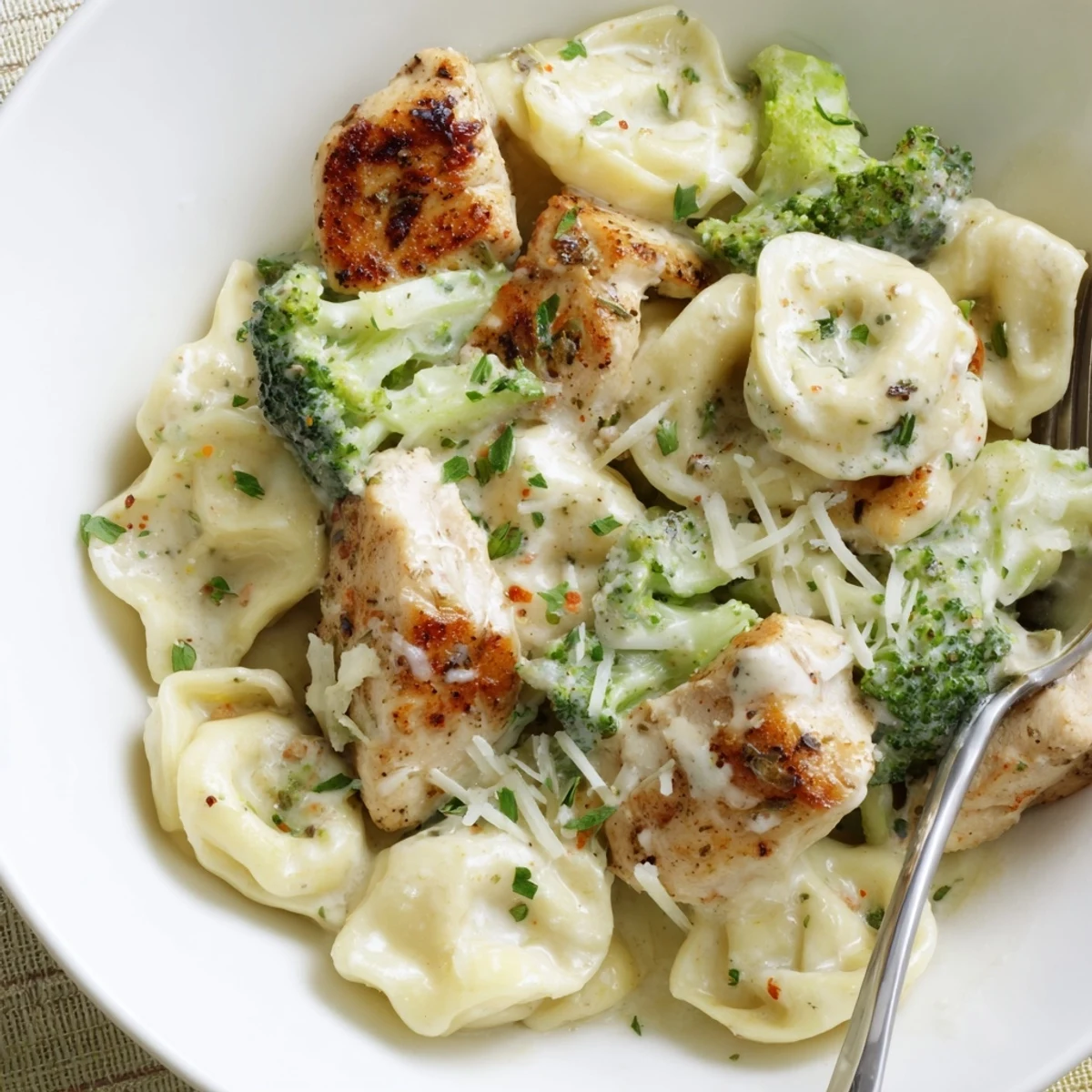 Creamy Garlic Parmesan Tortellini Chicken Broccoli served hot with extra grated Parmesan.