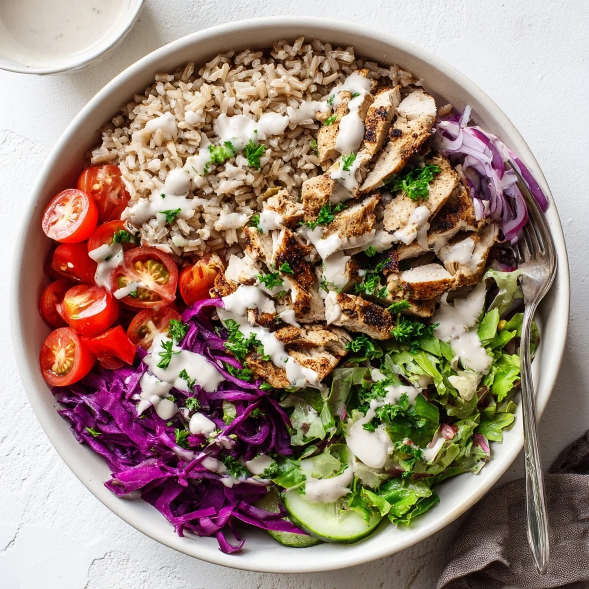 Vibrant healthy chicken shawarma bowl with spiced grilled chicken, fresh vegetables, and creamy tahini yogurt sauce