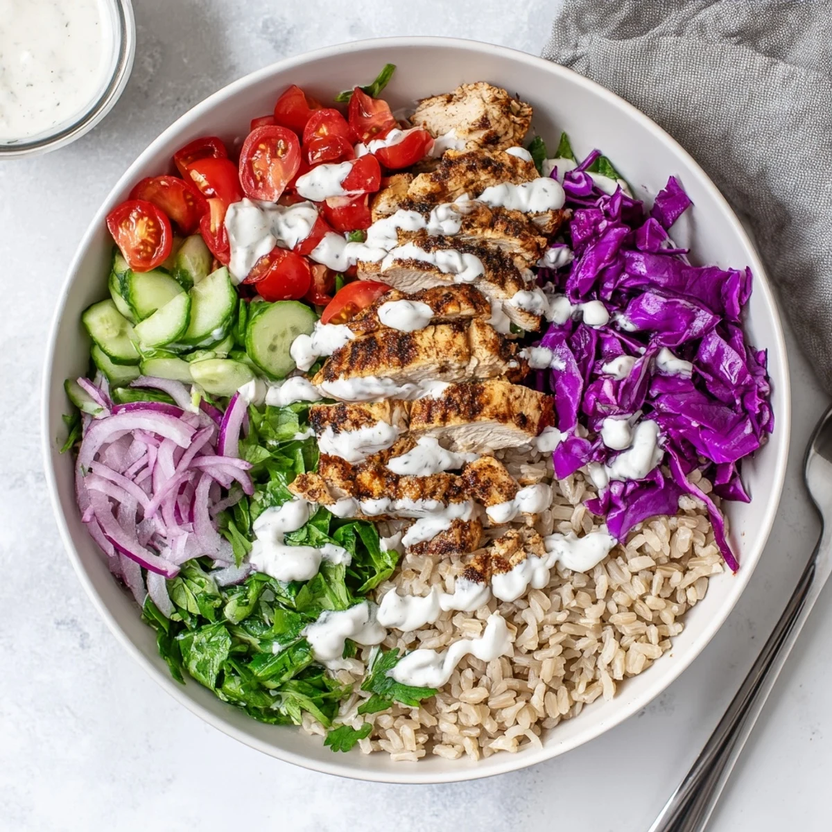 Wholesome healthy chicken shawarma bowl layered with brown rice, crisp veggies, and tender spiced chicken