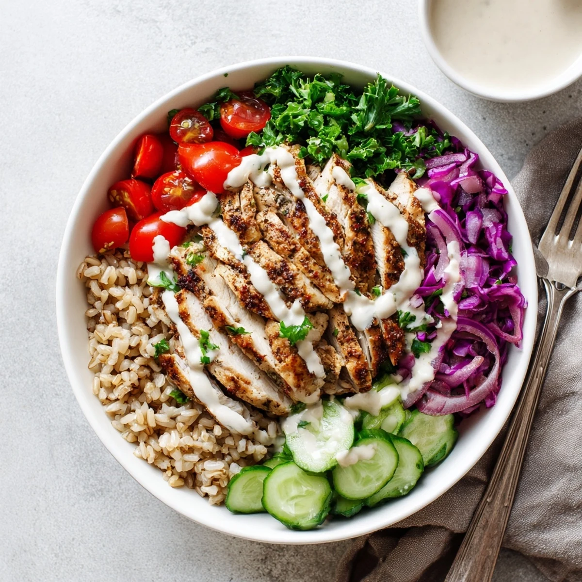 Nutritious chicken shawarma bowl recipe featuring marinated chicken slices over colorful vegetables and tangy yogurt drizzle