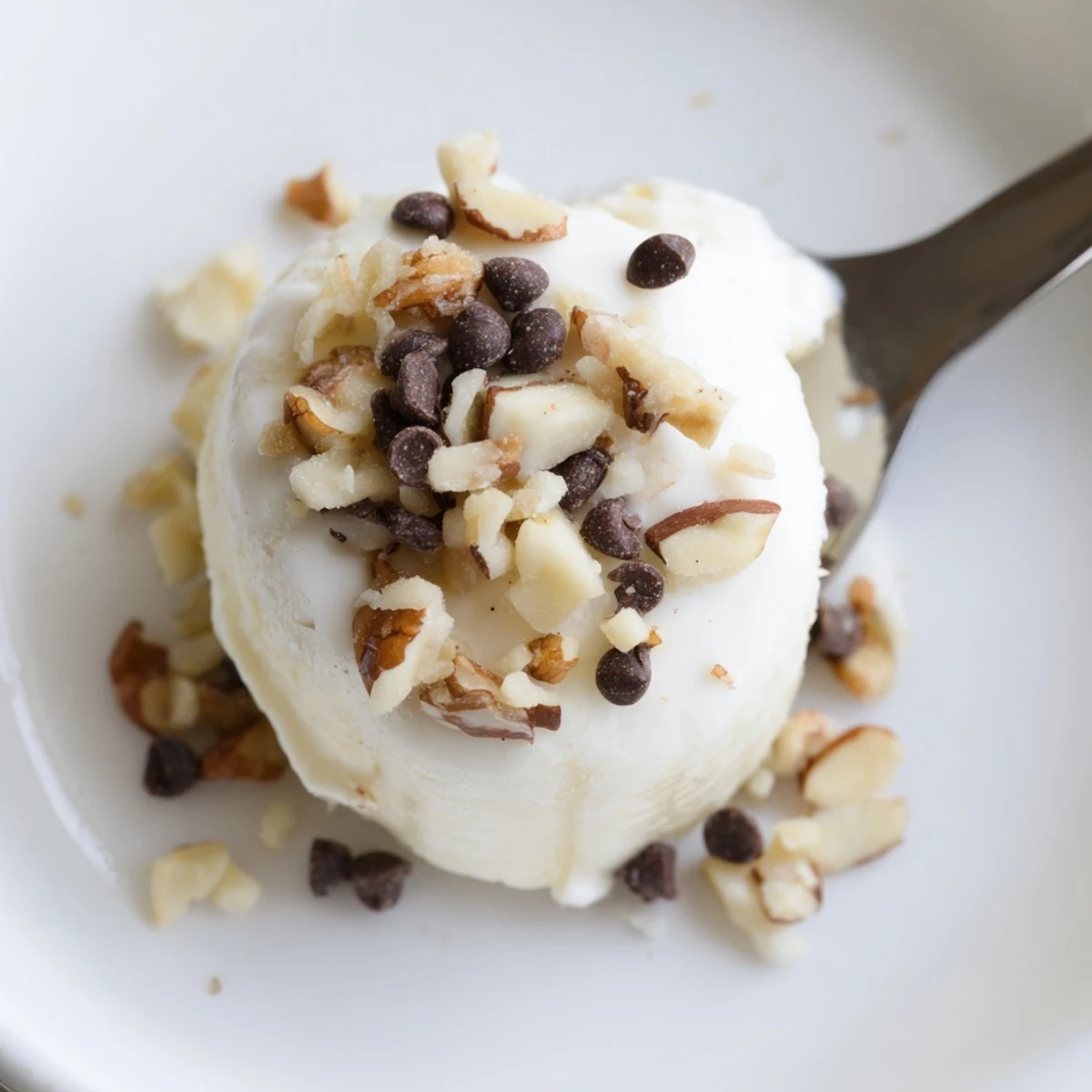 Close-up of Frozen Banana Yogurt Bites topped with shredded coconut, chilled and firm.