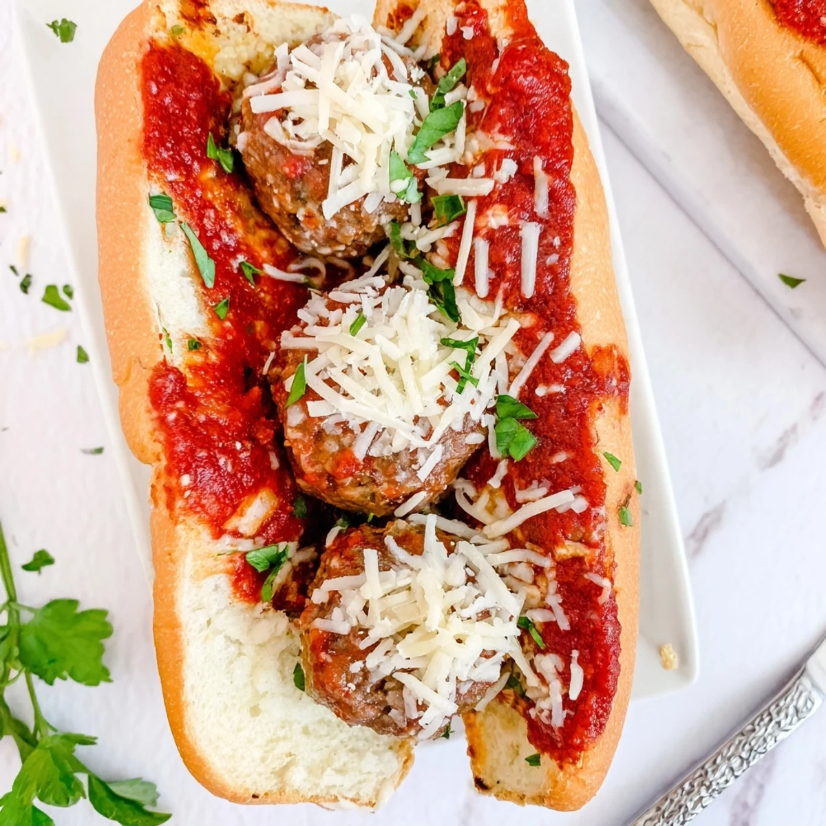 Golden toasted sub roll piled with juicy meatballs and marinara under melted mozzarella