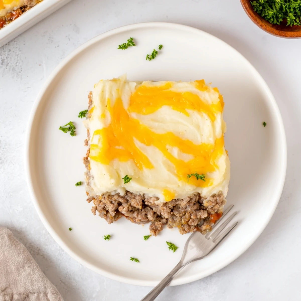 Baked Meatloaf Casserole glazed with sweet Dijon-ketchup sauce, garnished with parsley