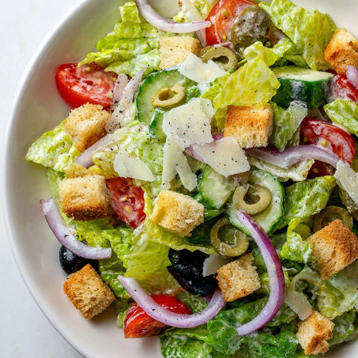 Crisp Olive Garden Salad tossed in creamy Italian dressing with crunchy croutons