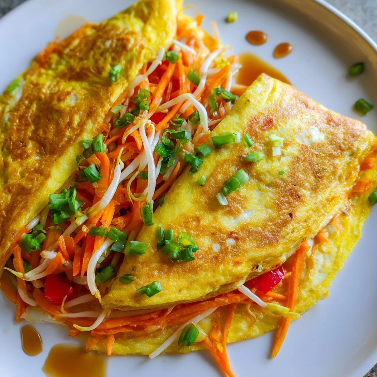 Savory Chinese omelette rolled with shredded carrots and garnished with cilantro and sliced scallions