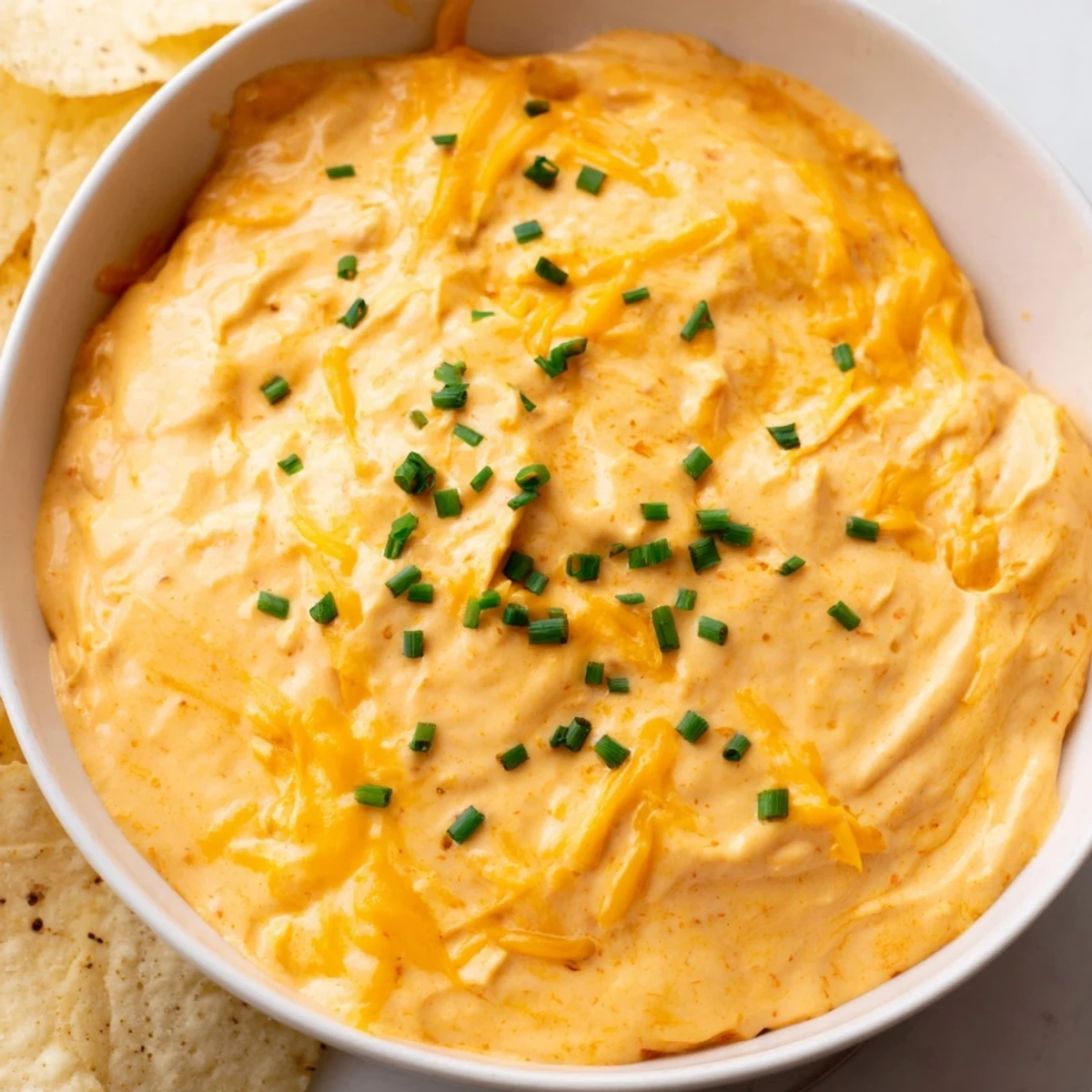 Bubbling cheese dip poured into a rustic bowl for game day