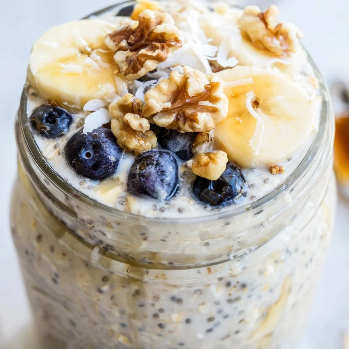 Velvety protein overnight oats served chilled in mason jars topped with chopped nuts