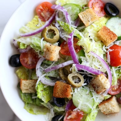 Fresh Olive Garden Salad topped with grated Parmesan and sliced pepperoncini peppers