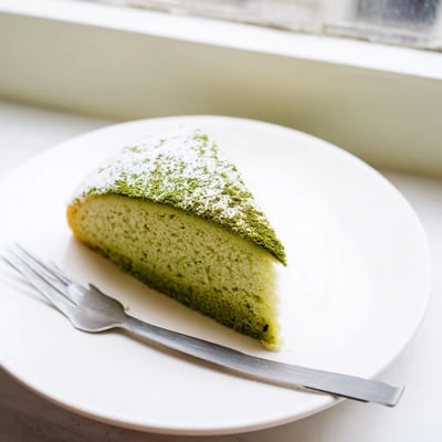 Two thick slices of this matcha cake recipe served with fresh berries for a refreshing dessert.